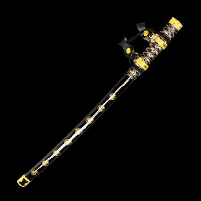 Sword with decorative black and gold sheath on a gray background