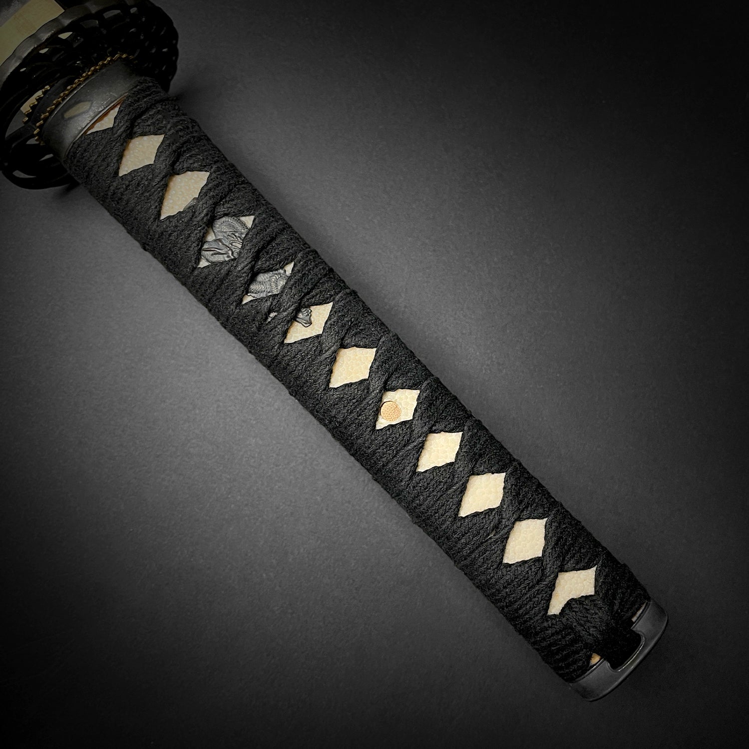 Close-up of Musha Iaido Martial Arts Practice Katana Sword handle with black braided wrapping