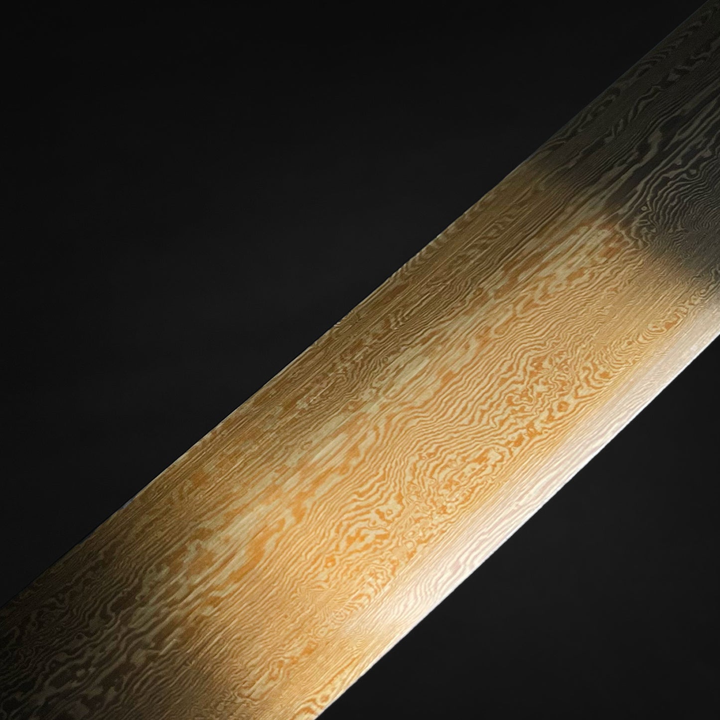 Close-up of the blade details on a Wholesale Damascus Katana for Sale by Musha with intricate patterns