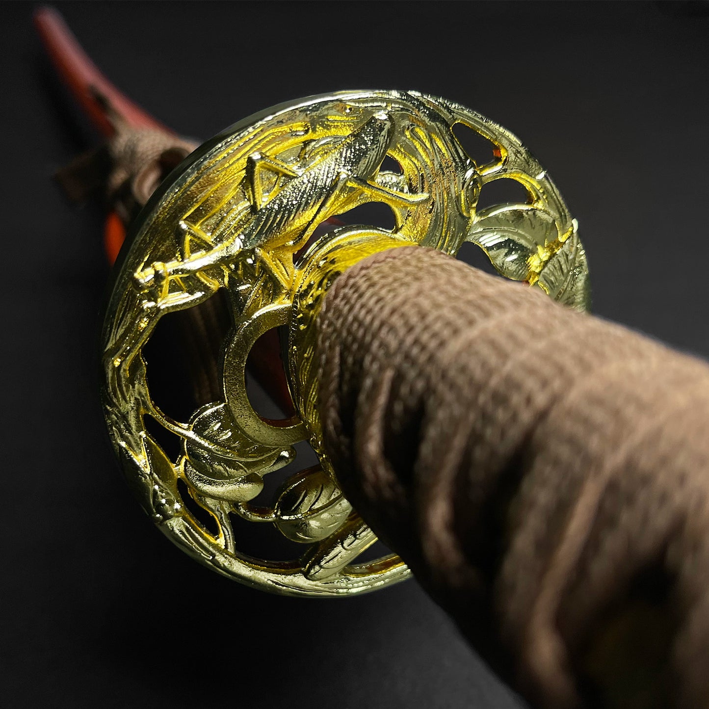 Close-up view of a Musha Wholesale Damascus Katana for Sale with intricate tsuba and wrapped handle