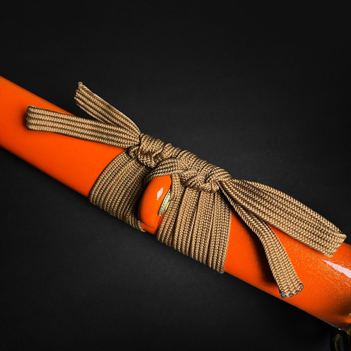 Detail of Musha Wholesale Damascus Katana for Sale with vibrant orange handle and decorative cord wrapping