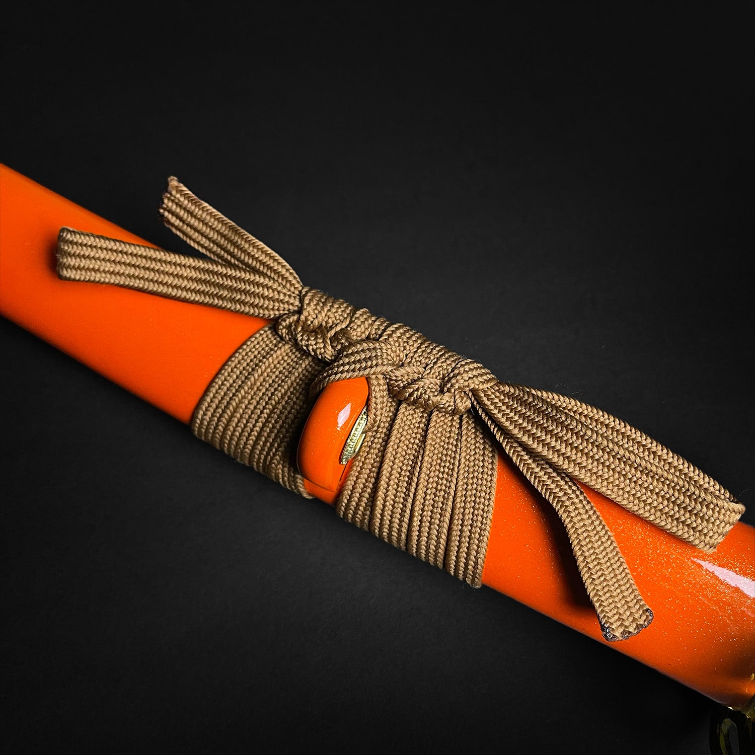 Detail of Musha Wholesale Damascus Katana for Sale with vibrant orange handle and decorative cord wrapping
