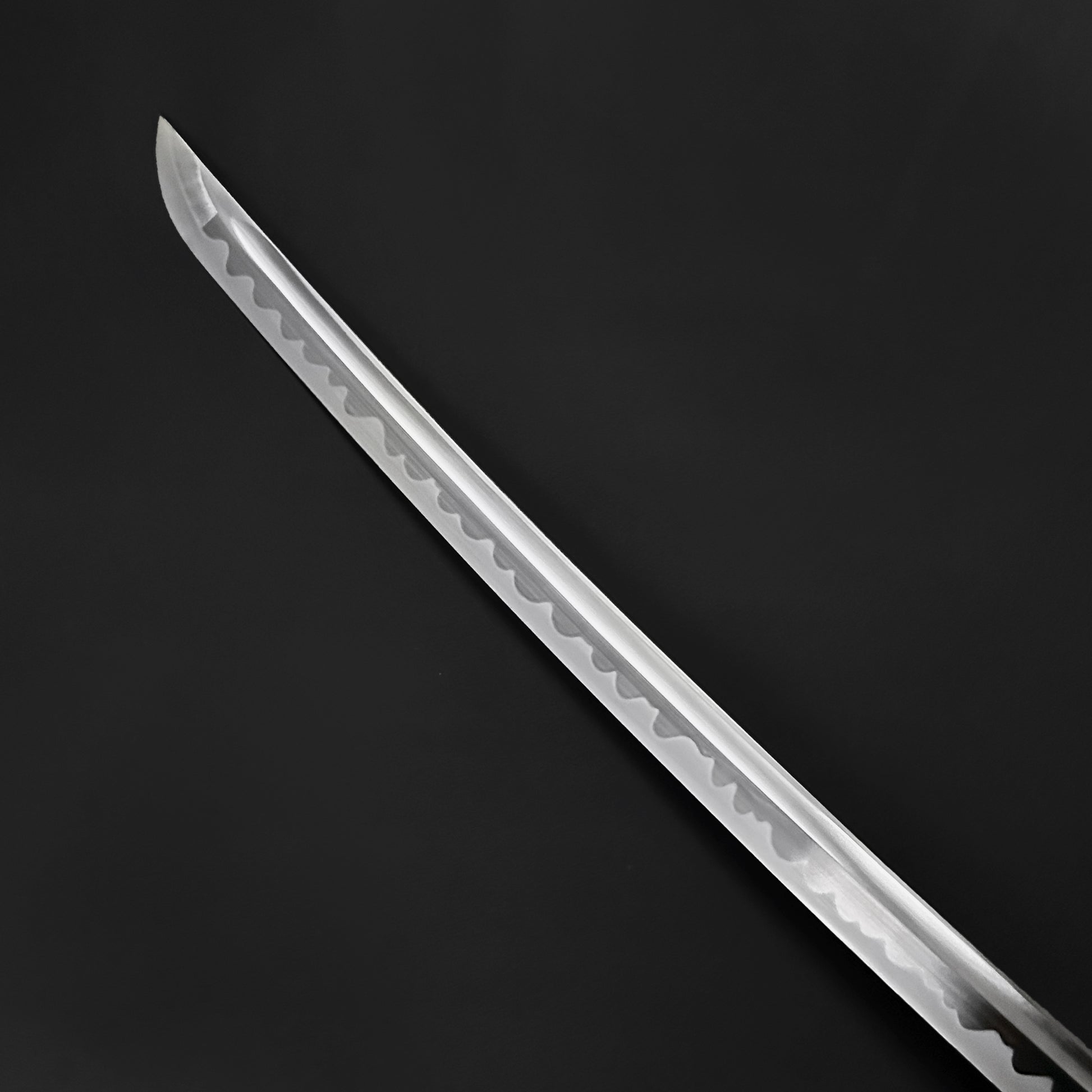 Close-up of the blade of a Wholesale Musashi Samurai Katana Sword showcasing its sharp, intricate design