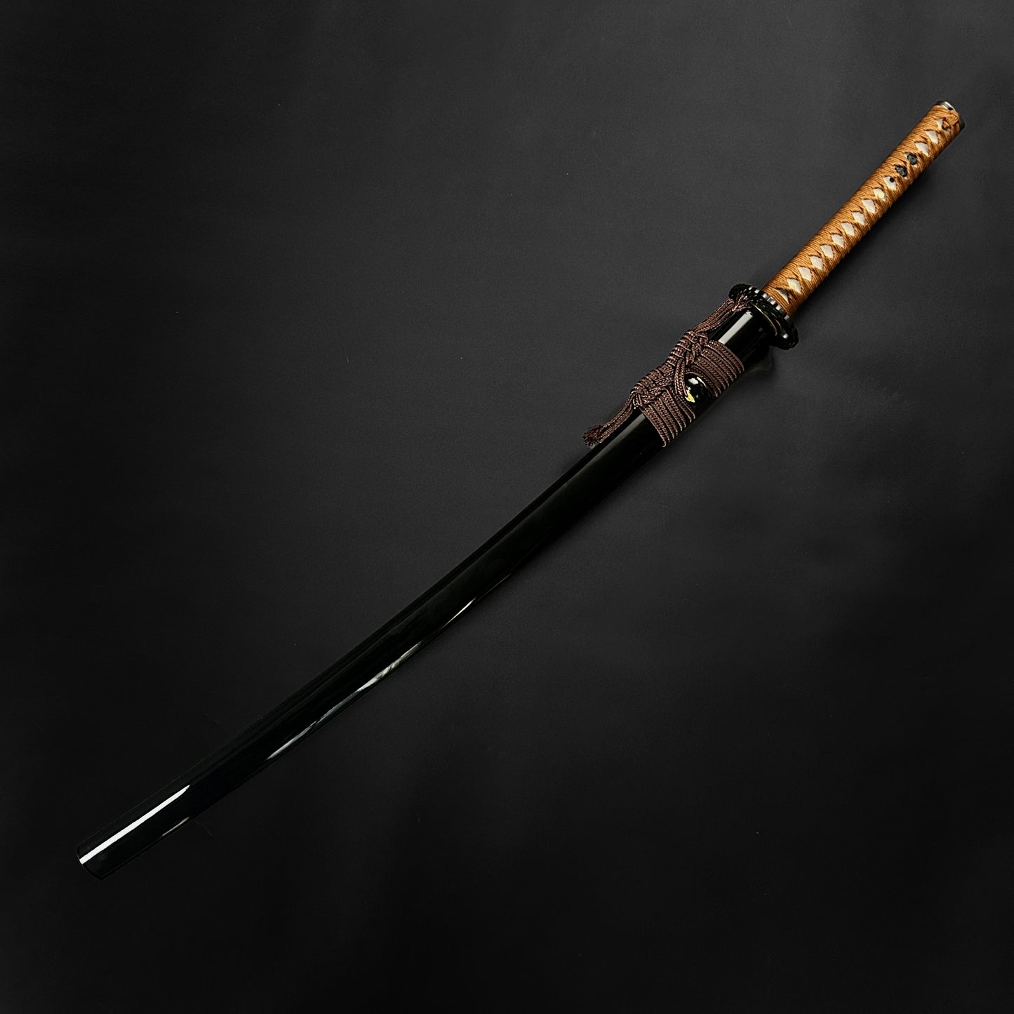 Wholesale Musashi Samurai Katana Sword with a sleek black blade and a traditional wrapped handle