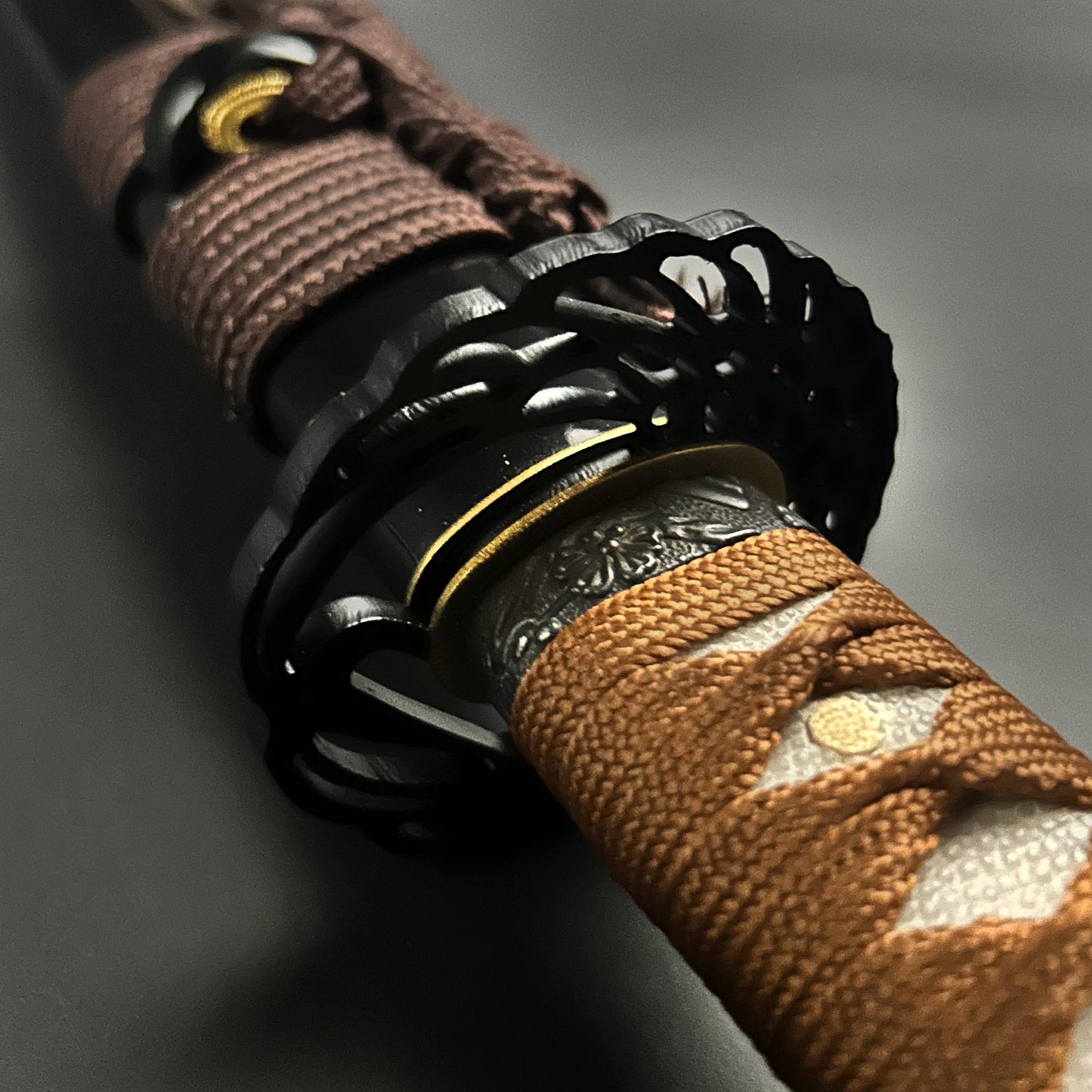 Close-up of Wholesale Musashi Samurai Katana Sword with detailed tsuba and tsuka wrapped in brown cord