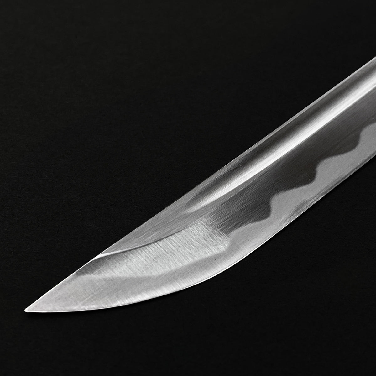 Close-up of the blade of a Wholesale Musashi Samurai Sword Katana showcasing its sharp edge and intricate design