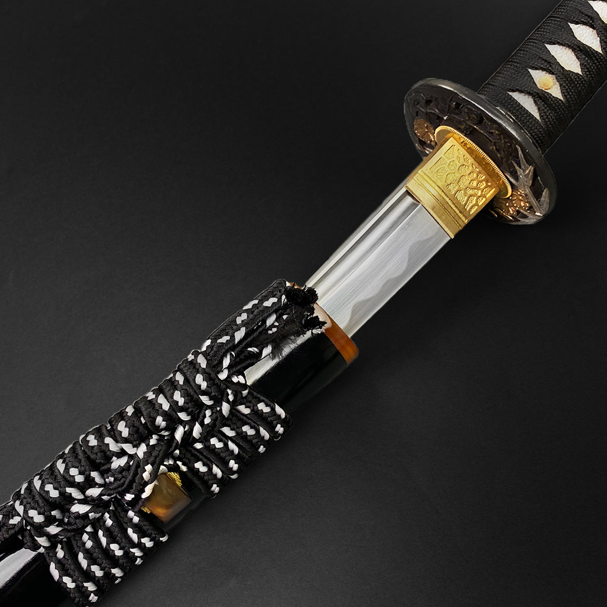 Close-up of Wholesale Musashi Samurai Sword Katana with intricate black and white handle wrapping