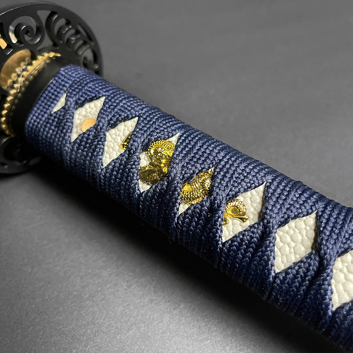 Close-up of Wholesale Musha Samurai Sword Katana handle with intricate blue cord wrapping and decorative elements