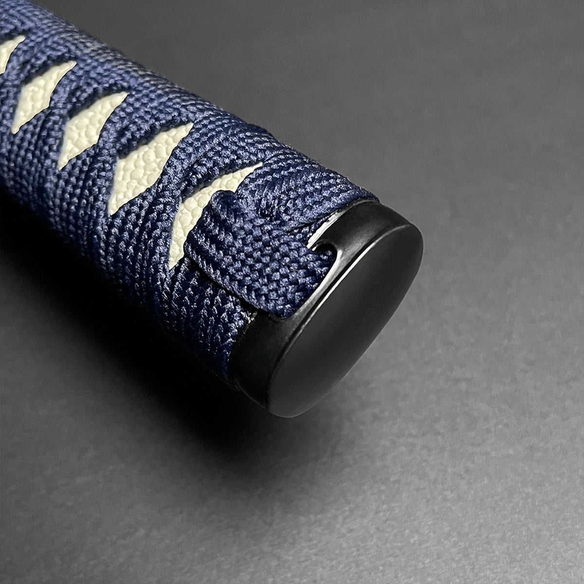 Close-up of the handle of a Wholesale Musha Samurai Sword Katana with blue wrapping and decorative cord