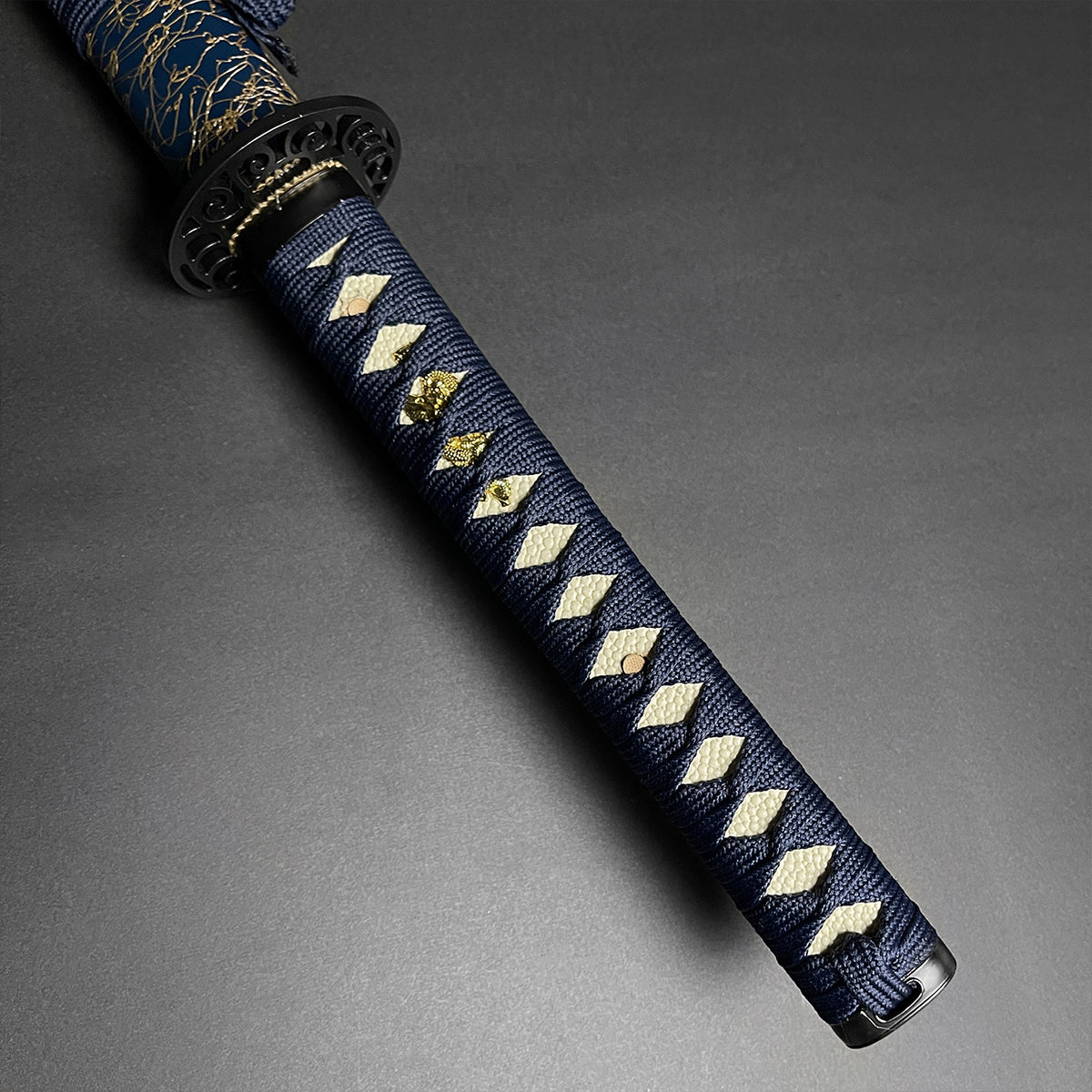 Detailed view of Wholesale Musha Samurai Sword Katana handle with intricate blue and gold design