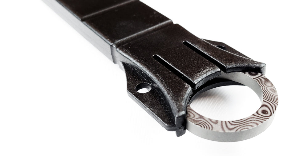 Close-up of Falcon Damascus tactical knife featuring a unique handle design and durable blade