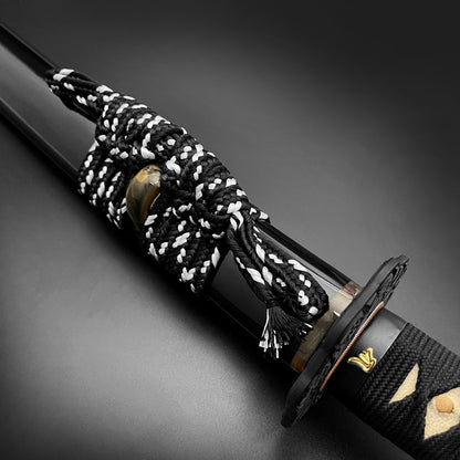 Musashi Katana for Sale featuring a black handle with intricate cord wrapping and polished blade