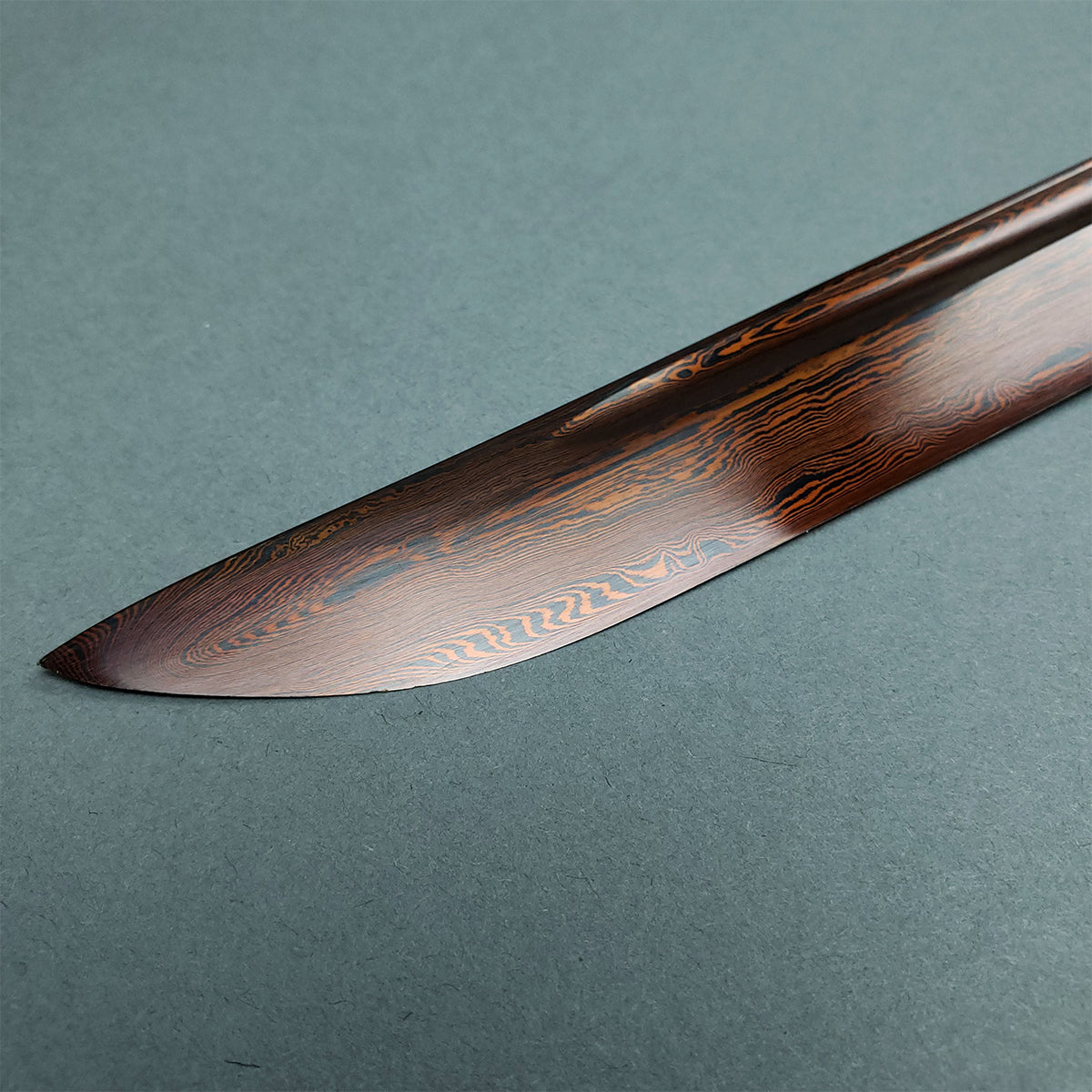 Musha Red Damascus Samurai Katana Sword with intricate, wavy blade design and polished finish