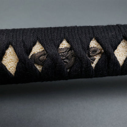 Musha Red Damascus Samurai Katana Sword handle featuring black cord wrapping and intricate dragon motifs