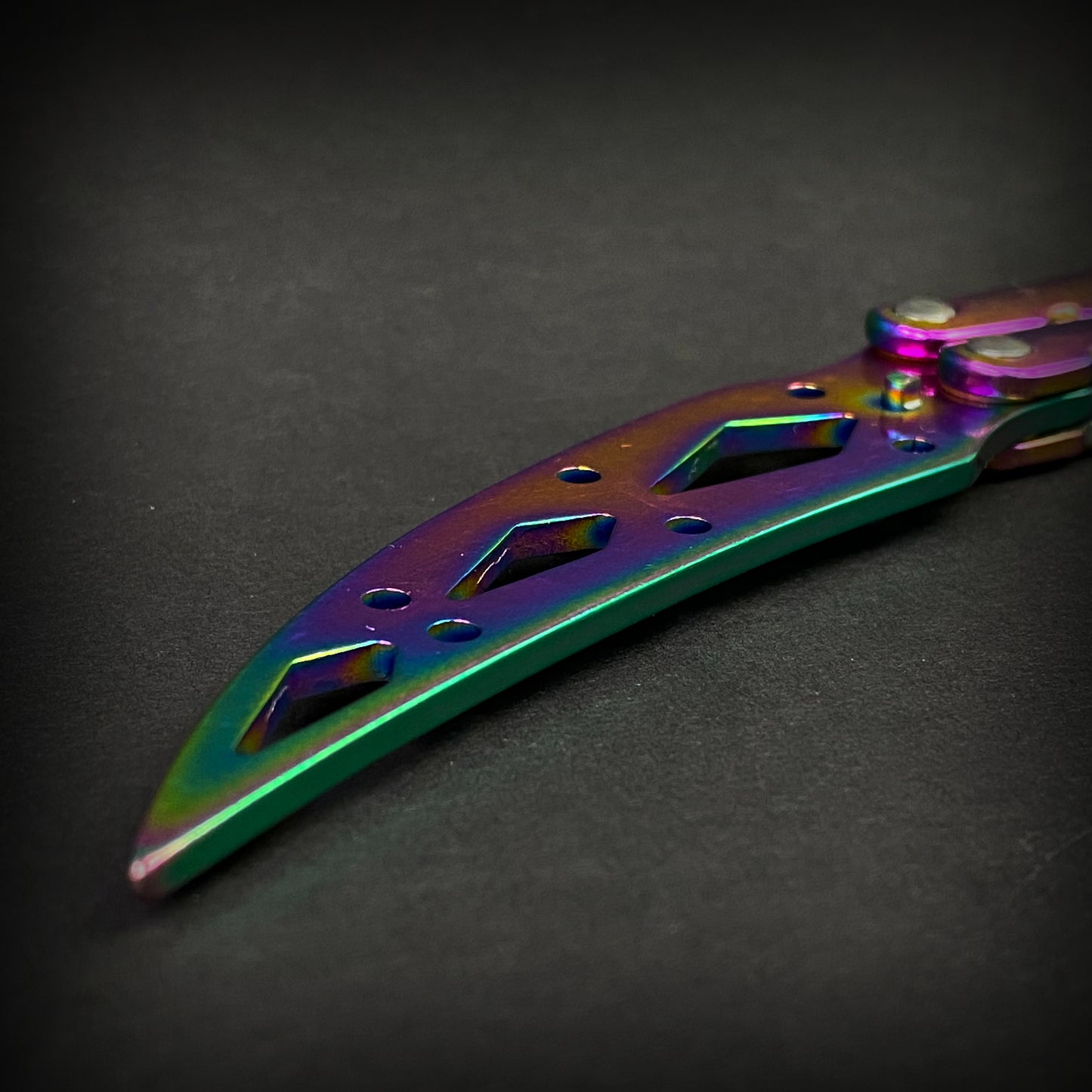 Rainbow Butterfly Trainer Balisong practice knife with a colorful metallic finish and unique design